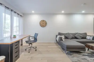 a living room with a couch and a desk at FREE PARKING PRIME LOCATION NEW MODERN CONDO in Brossard