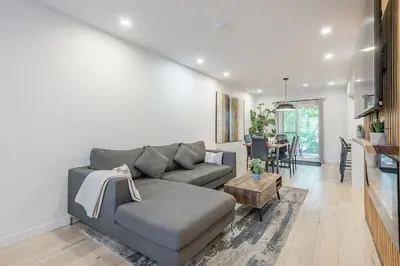 a living room with a couch and a table at FREE PARKING PRIME LOCATION NEW MODERN CONDO in Brossard