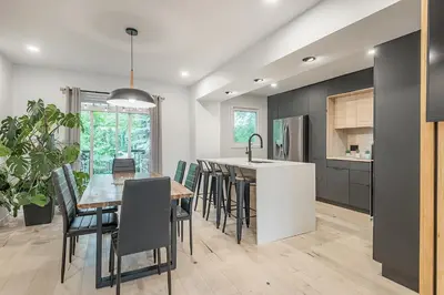 a kitchen and dining room with a table and chairs at FREE PARKING PRIME LOCATION NEW MODERN CONDO in Brossard