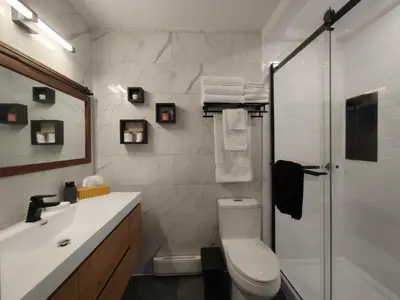 a bathroom with a shower and a toilet and a sink at Chalet Évasion Orford in Orford