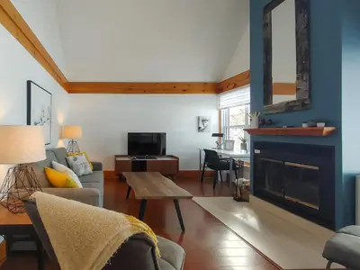 a living room with a couch and a fireplace at Chalet Évasion Orford in Orford