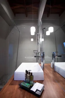 a bathroom with a white sink and a mirror at Le Pleasant Hôtel & Café in Sutton