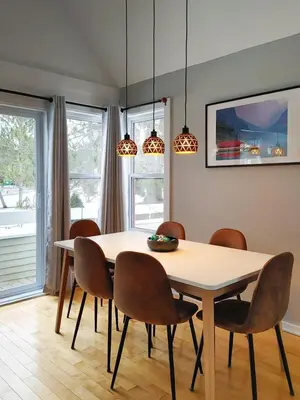 a dining room with a table and chairs at Chalet Escapade Orford in Orford