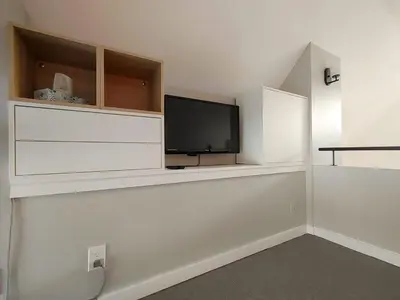 a living room with a flat screen tv on a wall at Chalet Escapade Orford in Orford