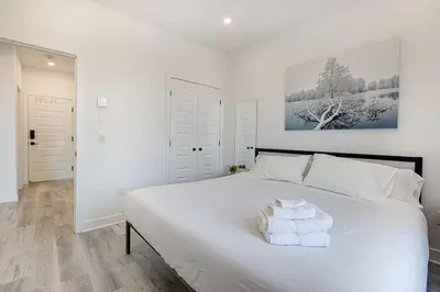 a bedroom with a large white bed with towels on it at Le Mile End by M11 - Neat & Spacious 1BDR Unit in Montréal