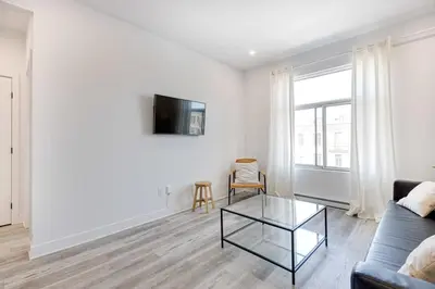 a living room with a couch and a glass table at Le Mile End by M11 - Neat & Spacious 1BDR Unit in Montréal