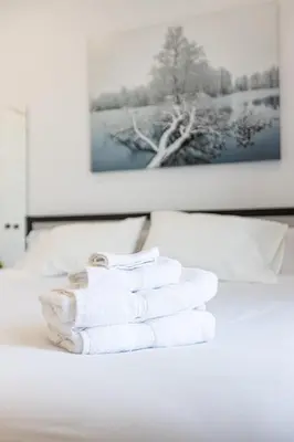 a pile of towels sitting on top of a bed at Le Mile End by M11 - Neat & Spacious 1BDR Unit in Montréal