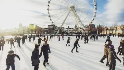a group of people skating on an ice rink with a ferris wheel at Le Mile End by M11 - Neat & Spacious 1BDR Unit in Montréal