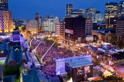 a large crowd of people in a city at night at 2 bedroom Condo in the heart of the city Montreal in Montréal