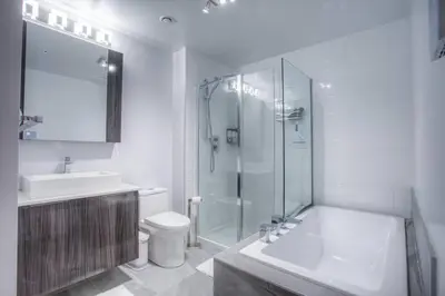 a bathroom with a shower and a toilet and a sink at 2 bedroom Condo in the heart of the city Montreal in Montréal