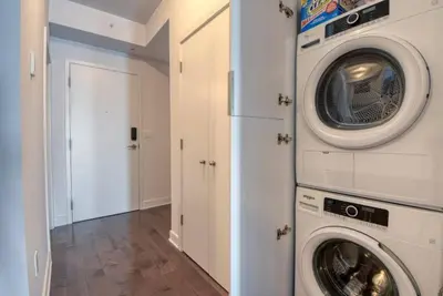 a laundry room with a washer and dryer at 2 bedroom Condo in the heart of the city Montreal in Montréal