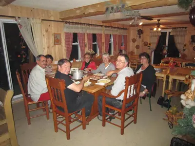 a group of people sitting around a table at Le Gîte Ambrelane in Thetford Mines