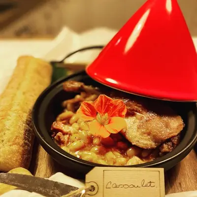 a black bowl of food with a flower on top at Glamping 4 saisons @ Eco Lodge Bûcheron Bergère in Ormstown