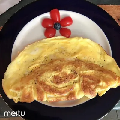 a white plate with an omelet on a plate at La Loggia Art B&B in Montréal
