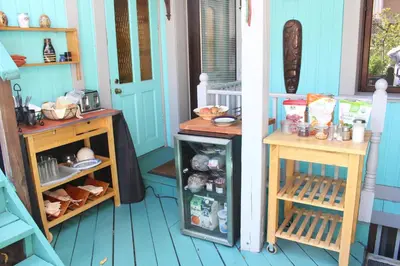 a room with two tables and a refrigerator at La Loggia Art B&B in Montréal