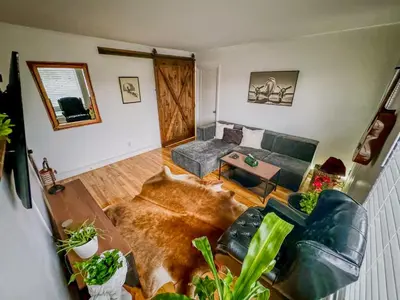 a living room with a couch and a table at Barel Residence Homestay in Longueuil