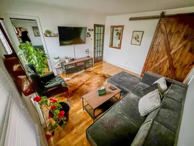 a living room with a couch and a table at Barel Residence Homestay in Longueuil