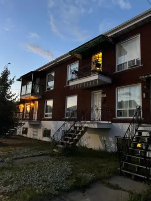 a brick apartment building with stairs and windows at Barel Residence Homestay in Longueuil