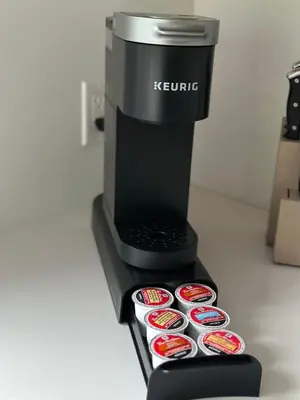 a black coffee maker with several cups on a counter at Le Joford in Orford