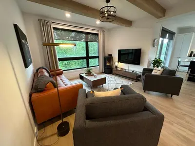 a living room with two couches and a tv at Le Joford in Orford