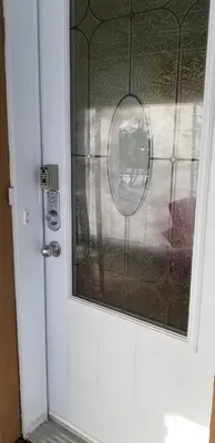 a glass door with a mirror on it at Maisonnette dans la nature en pleine ville. in Trois-Rivières