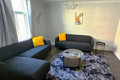 a living room with two couches and a coffee table at Spacieux Appartement de 3 Chambres downtown in Montréal