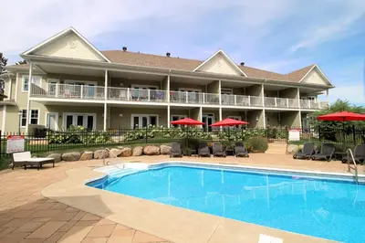 a resort with a swimming pool in front of a building at LeChamplain #206 CITQ#248275 in Bromont