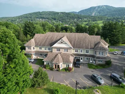 an aerial view of a large house with a parking lot at LeChamplain #206 CITQ#248275 in Bromont