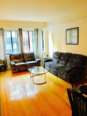 a living room with a couch and a coffee table at Stylish Montreal Apartment: Comfortable Stay in the Golden Square Mile in Montréal