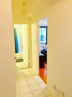 a view of a hallway from a room with a bathroom at Stylish Montreal Apartment: Comfortable Stay in the Golden Square Mile in Montréal