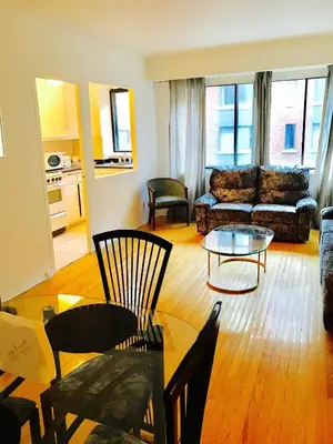 a living room with a couch and a table at Stylish Montreal Apartment: Comfortable Stay in the Golden Square Mile in Montréal