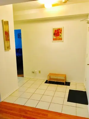 a room with a bench and a painting on the wall at Stylish Montreal Apartment: Comfortable Stay in the Golden Square Mile in Montréal