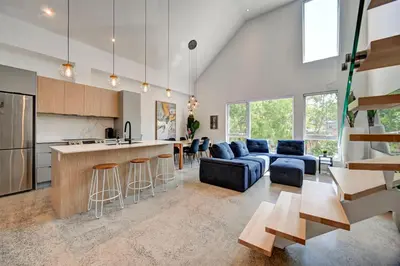 a kitchen and living room with a couch and a table at Luxury Penthouse 3BR 2BR Downtown Private Roof Terrace presented by TripMontreal in Montréal