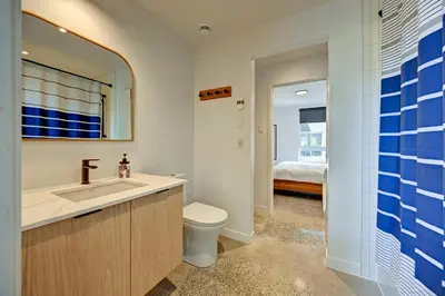 a bathroom with a sink and a toilet and a mirror at Luxury Penthouse 3BR 2BR Downtown Private Roof Terrace presented by TripMontreal in Montréal