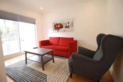 a living room with a red couch and a table at Luxueux - Deco moderne, Rosemont in Montréal