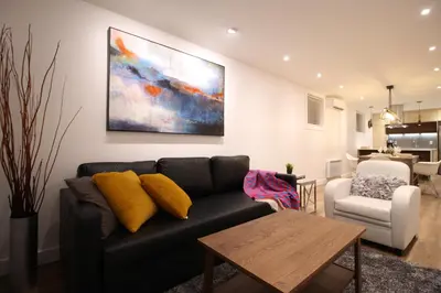 a living room with a couch and a table at Luxueux - Deco moderne, Rosemont in Montréal