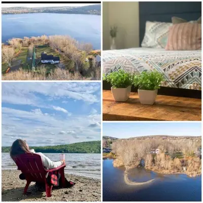 a woman sitting in a chair next to a bed and a lake at Chalet BIA - Cap au Sud in Trois-Lacs