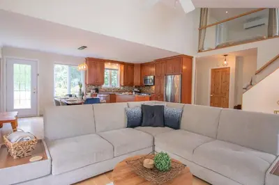 a living room with a couch and a table at Chalet BIA - Cap au Sud in Trois-Lacs