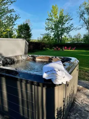 a hat sitting on top of a barbecue grill at Chalet BIA - Cap au Sud in Trois-Lacs