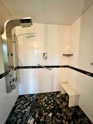 a bathroom with a shower and a bench in it at Chalet BIA - Au courant des 2 rivières in Weedon-Centre
