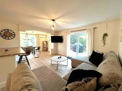 a living room with a couch and a table at Chalet BIA - Au courant des 2 rivières in Weedon-Centre
