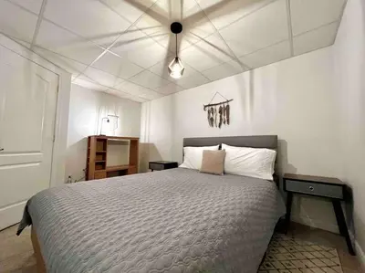 a bedroom with a large bed with a ceiling at Chalet BIA - Au courant des 2 rivières in Weedon-Centre