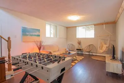 a living room with a large foosball table at Chalet BIA Foyer & Spa in Trois-Lacs