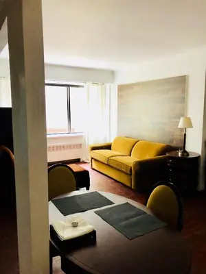 a living room with a couch and a table at Stylish Montreal Apartment: Comfortable Stay in the Golden Square Mile in Montréal