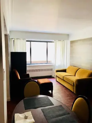 a living room with a couch and a table at Stylish Montreal Apartment: Comfortable Stay in the Golden Square Mile in Montréal