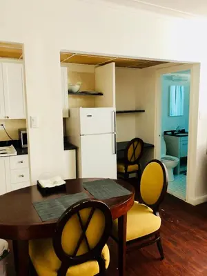 a kitchen and dining room with a table and chairs at Stylish Montreal Apartment: Comfortable Stay in the Golden Square Mile in Montréal