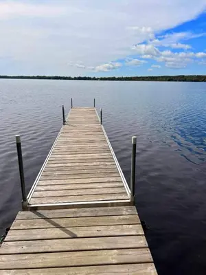 a wooden dock in the middle of a lake at Chalet Le Shack O2 in Stratford