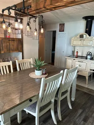 a kitchen with a wooden table and chairs and a table and a tableablish at Chalet Le Shack O2 in Stratford
