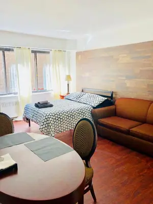 a living room with two beds and a couch at Stylish Montreal Apartment: Comfortable Stay in the Golden Square Mile in Montréal