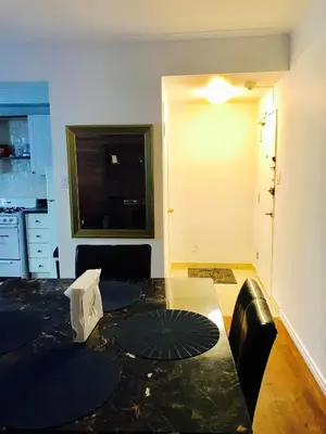 a living room with a table with an umbrella on it at Stylish Montreal Apartment: Comfortable Stay in the Golden Square Mile in Montréal